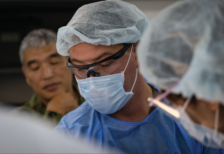 Navy Lieutenant Commander James Harrison, orthopedic surgeon with 3rd Medical Battalion, 3rd Marine Logistics Group, communicates criticalpatient information with Japan Ground Self-Defense Force members during damage control resuscitation drill as part of exercise Keen Sword25 at Camp Ishigaki, Okinawa, Japan, October 24, 2024 (U.S. Marine Corps/JVonnta Taylor)
